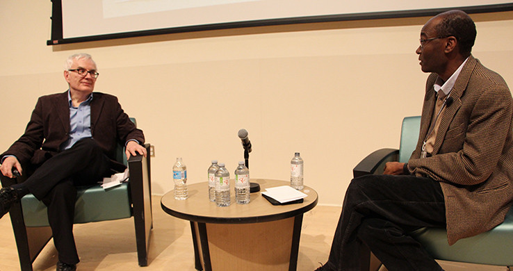 Comedian Rick Green and Dr. Ahmed sitting in armchairs and talking