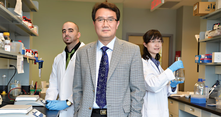 three scientists standing and looking forward
