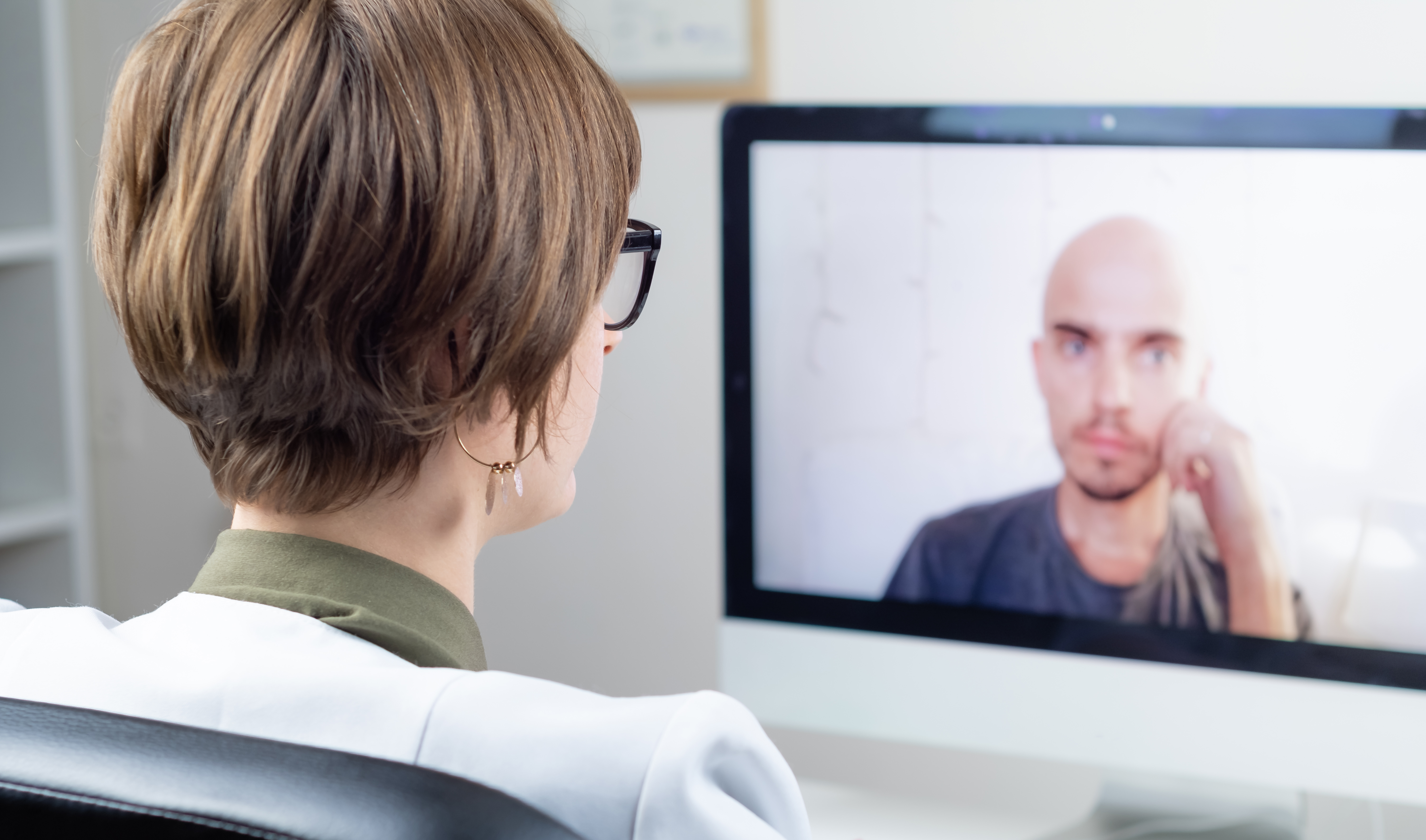 Physician speaking with patient via telehealth