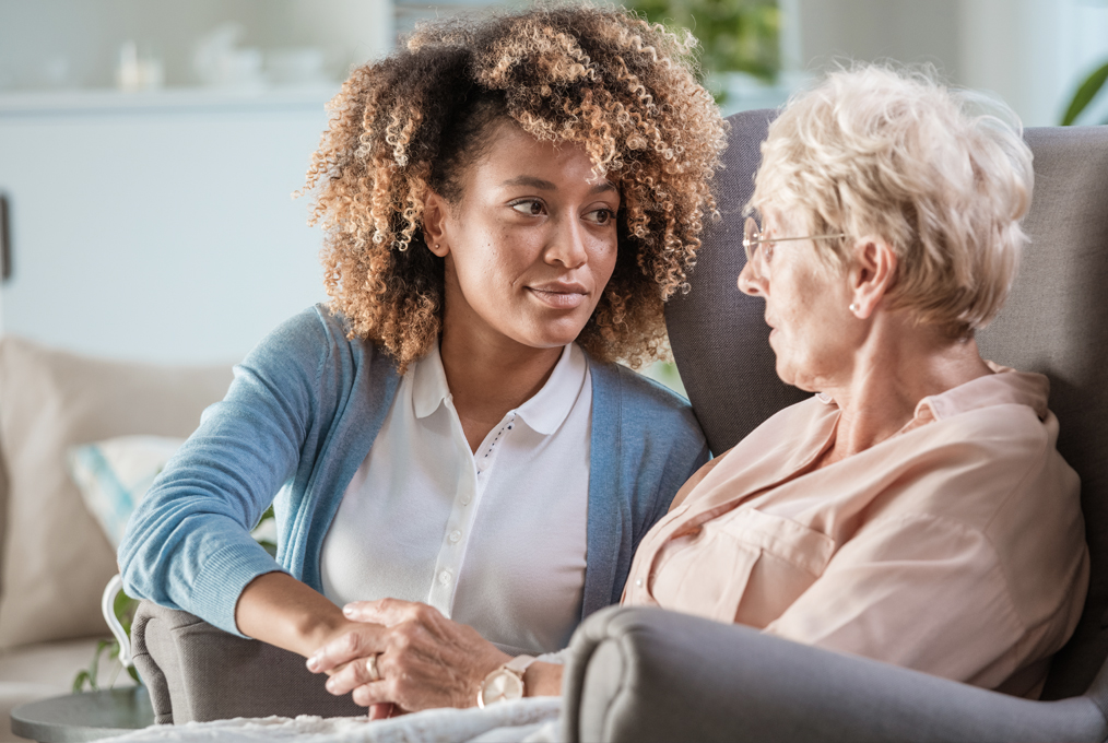 A health care worker with a client in her own home.