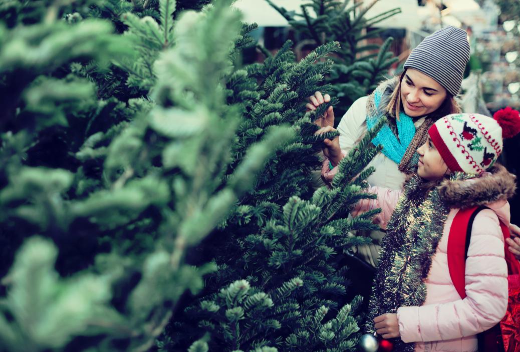 Mom and daughter buying Christmas tree