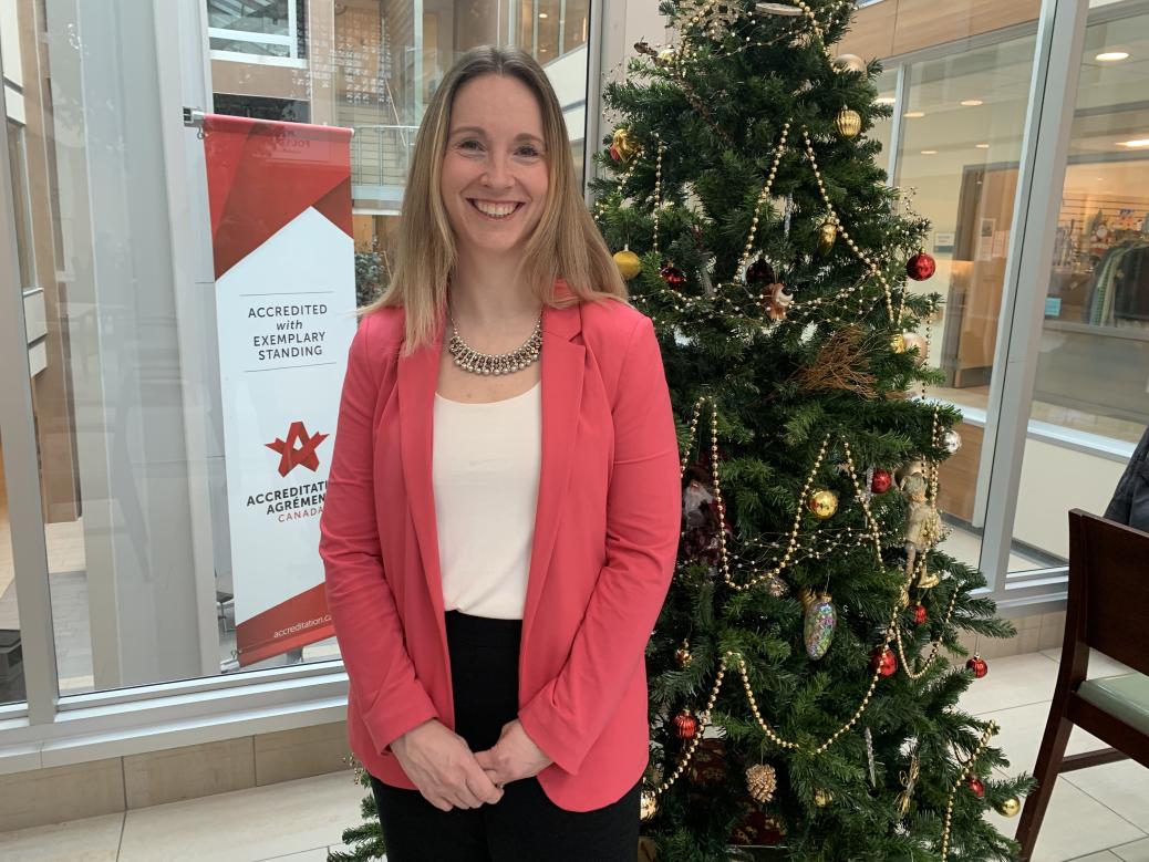 Jillian Crabbe standing in front of Christmas tree