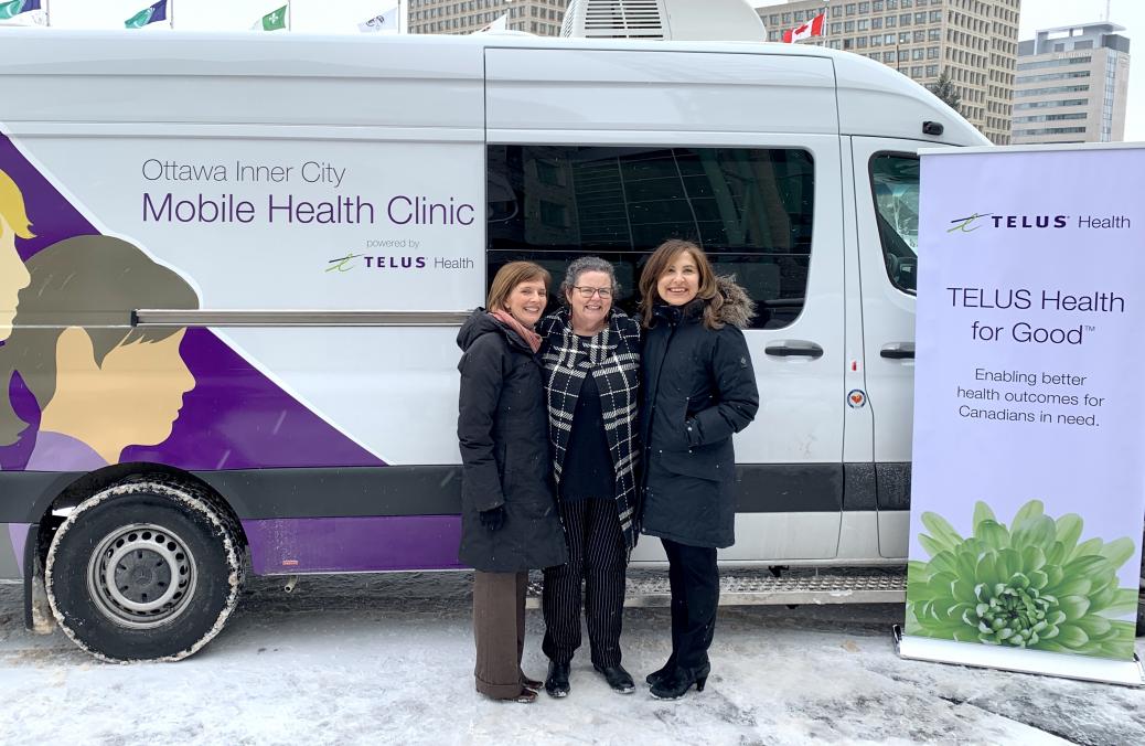 Dr. Susan Farrell, vice president of patient care services and community mental health at The Royal; Wendy Muckle, CEO of Ottawa Inner City Health; and Jill Schnarr, vice president of corporate citizenship and communications at Telus in front of van.
