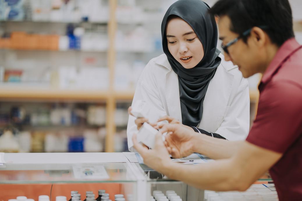 Pharmacist speaking with customer