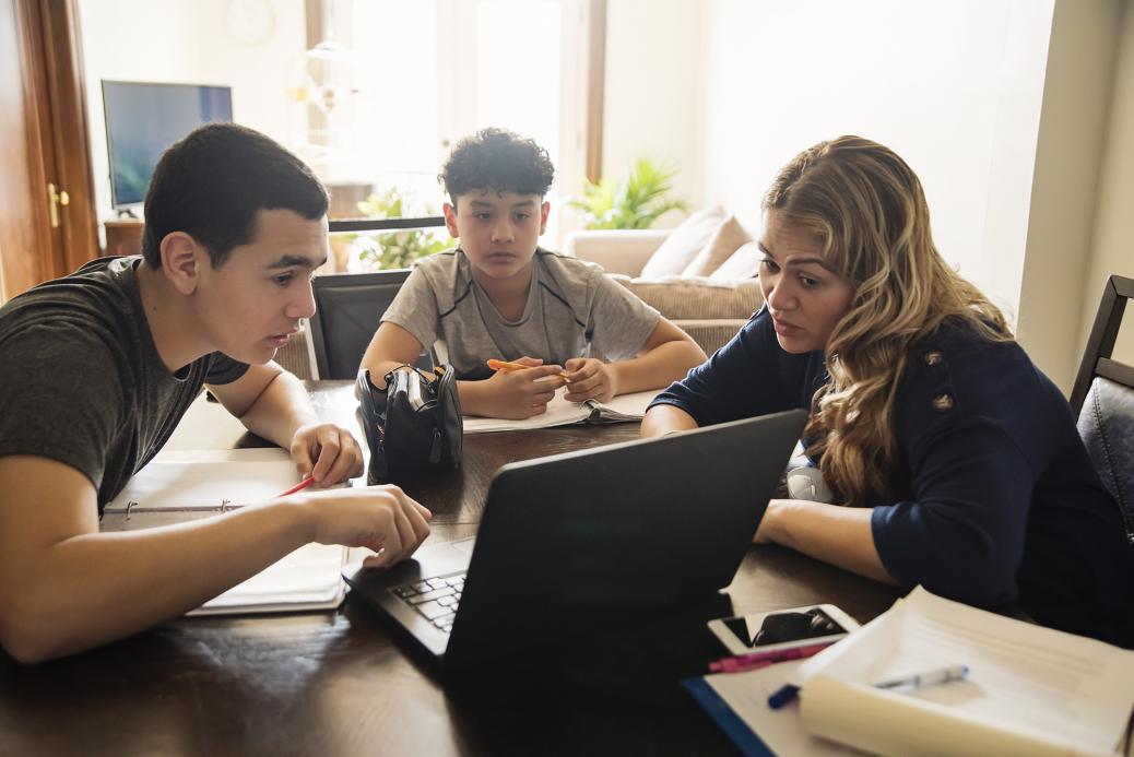 Mom helping her kids with homework