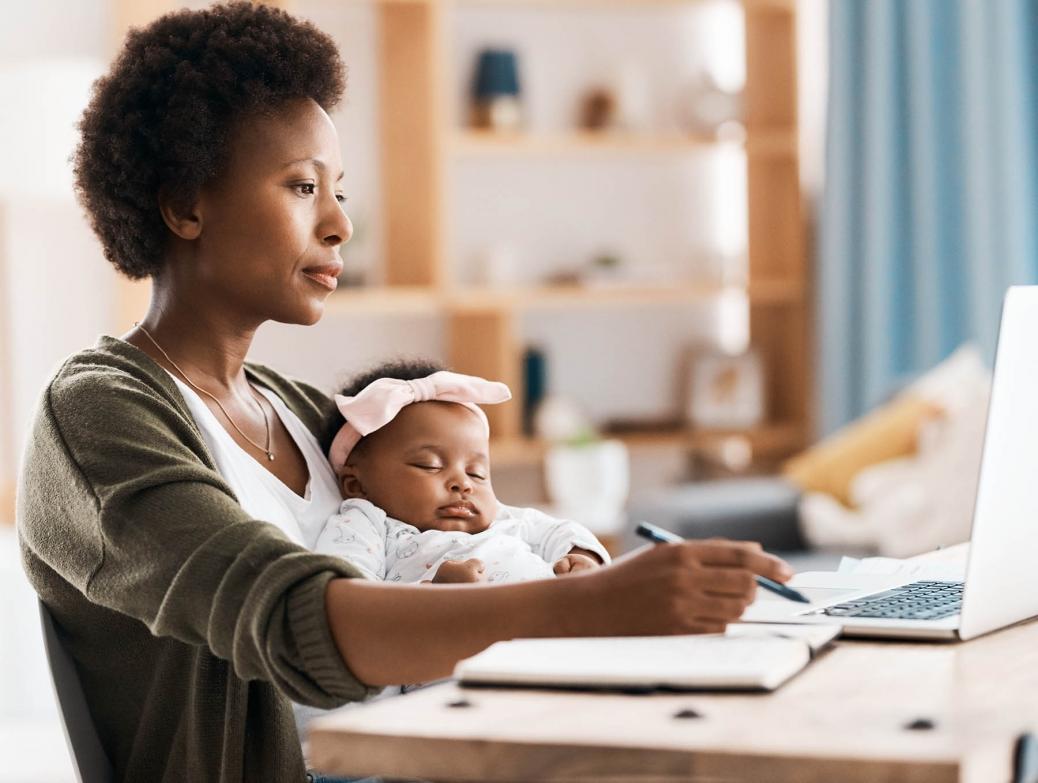 Mom journaling with baby on her lap