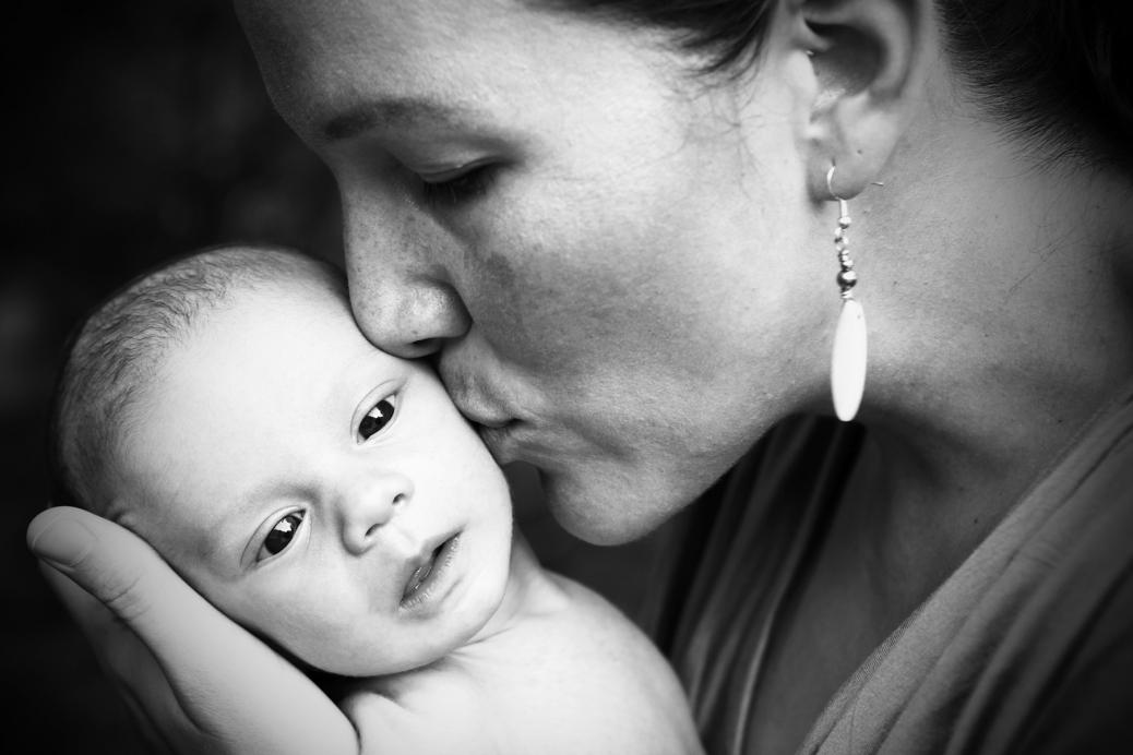 Mother kissing her baby