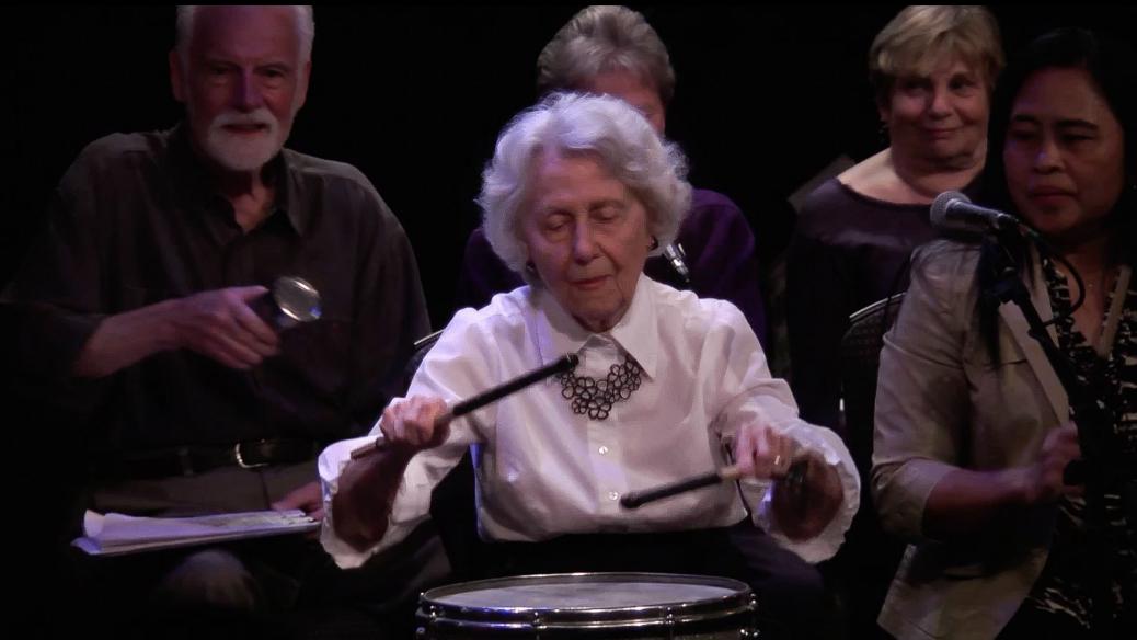 Older woman playing drums