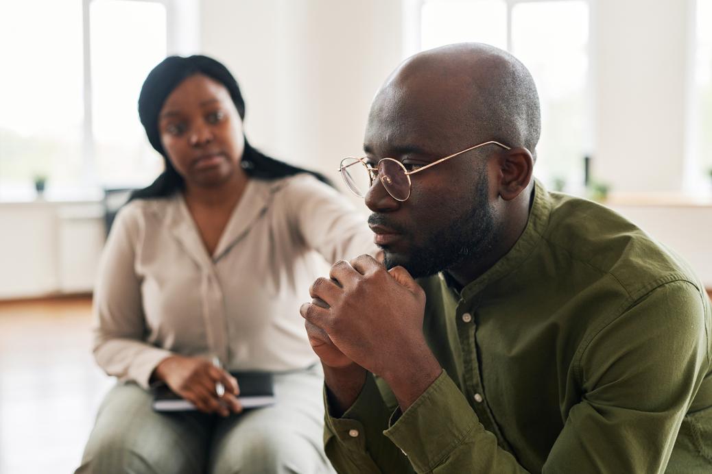 A Black man attending a peer support session.