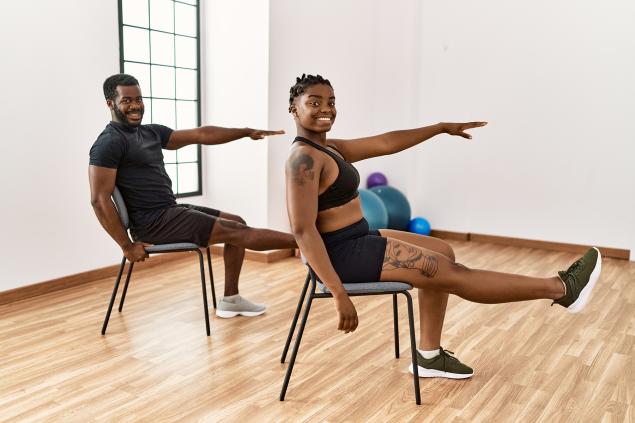 Two people doing chair exercises
