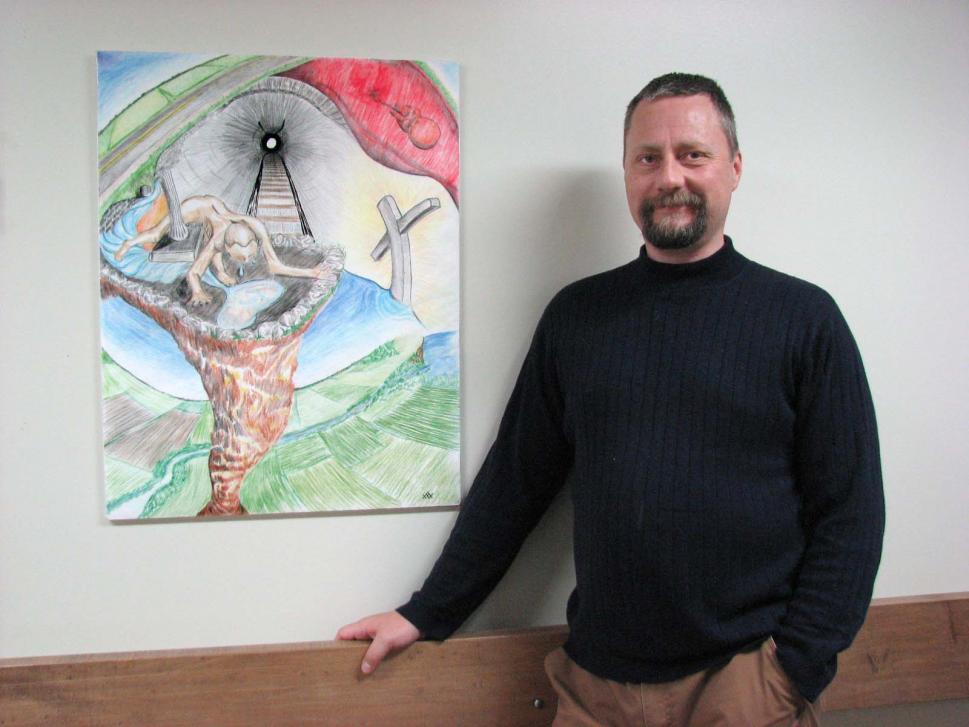 Mike, a member of the Client Advisory Council at the Brockville Mental Health Centre stands by his painting