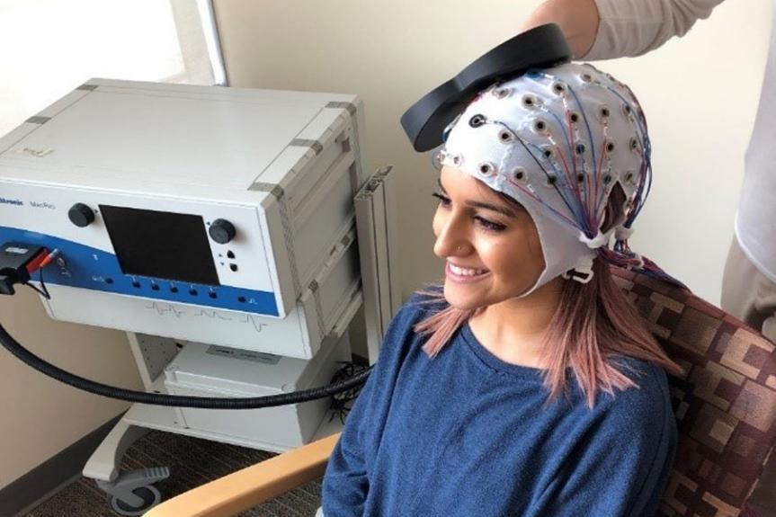 Women wearing a Repetitive transcranial magnetic stimulation (rTMS)