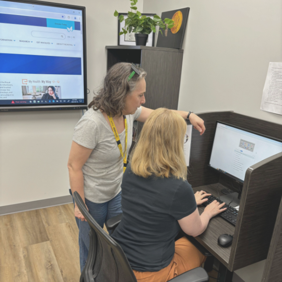 Christine showing individual something on computer