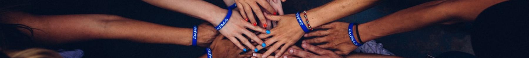 banner image of many hands coming together