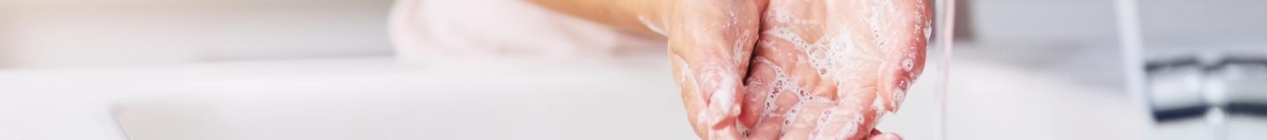 Woman washing hands in sink