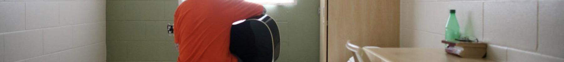 Safety Through Recovery Patient playing guitar while sitting on bed in bedroom