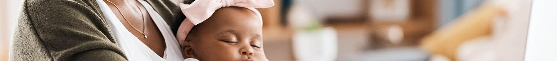 Perinatal Journaling as a wellness
tool Mom journaling with baby on her lap