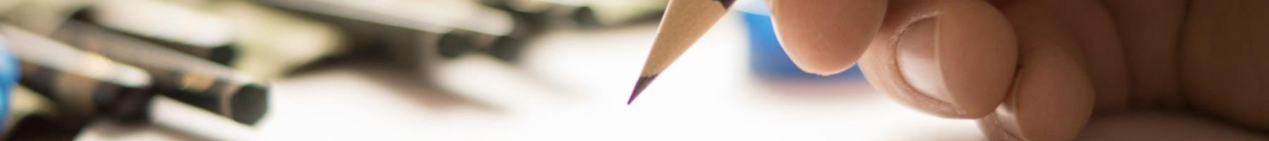 A hand holding a pencil while sketching group designed to create and heal