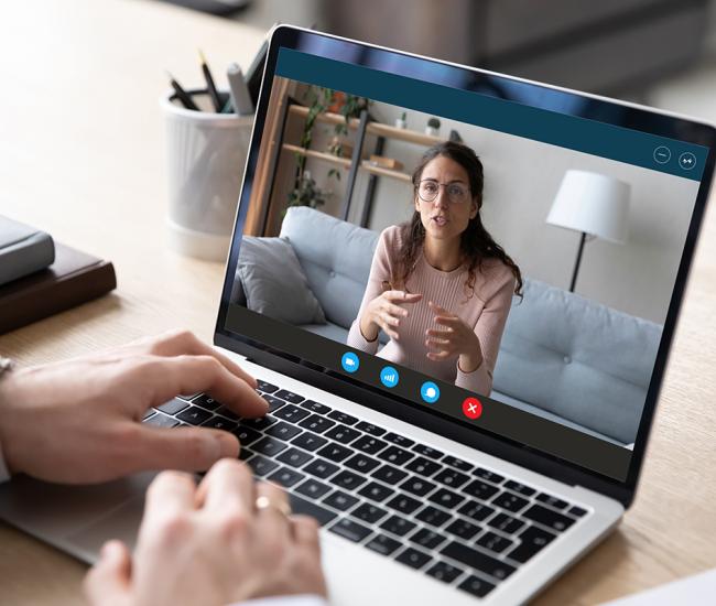 Person attending virtual appointment on laptop