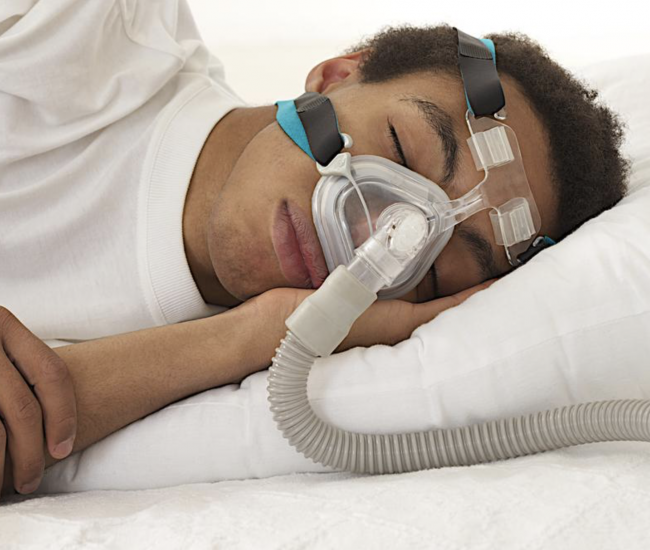 Man sleeping with a CPAP machine