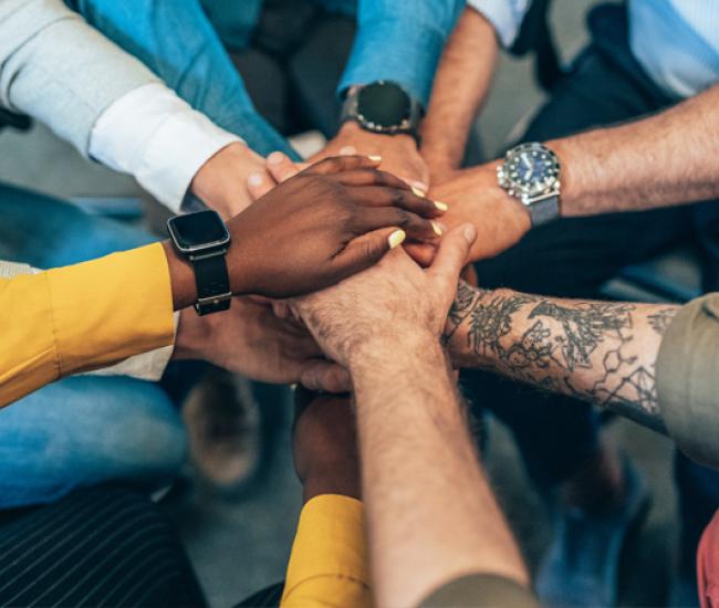 A collection of hands over top one another