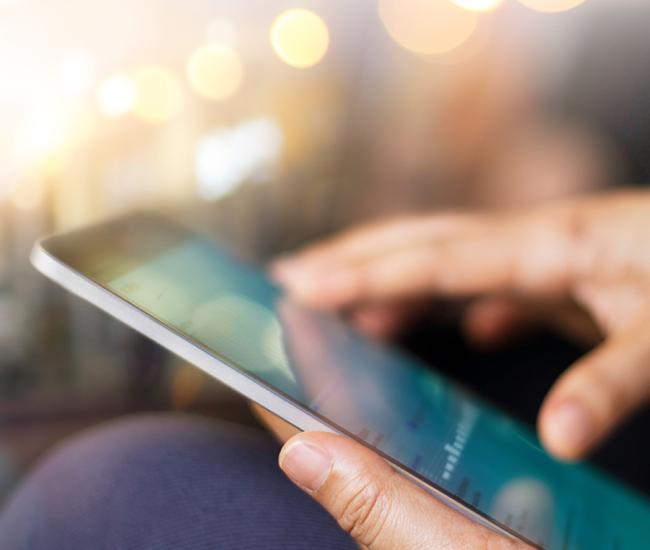 Close up of hands using a tablet