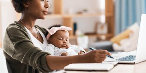 Mom journaling with baby on her lap