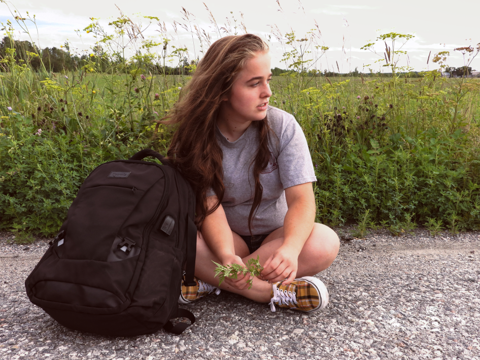 Girl sitting with her backpack