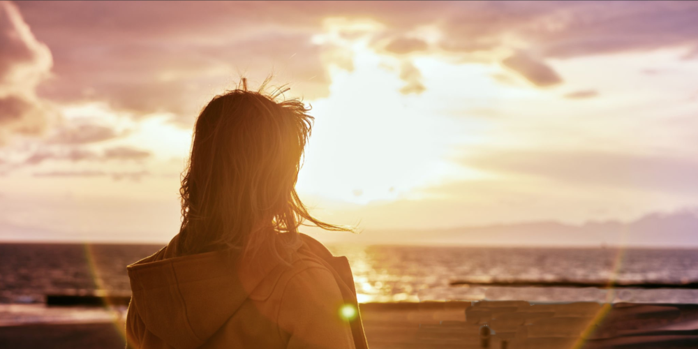 Woman looking into sunset