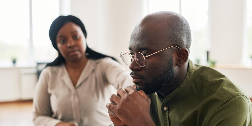 A Black man attending a peer support session.