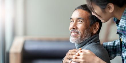 Man looking over shoulder at caregiver