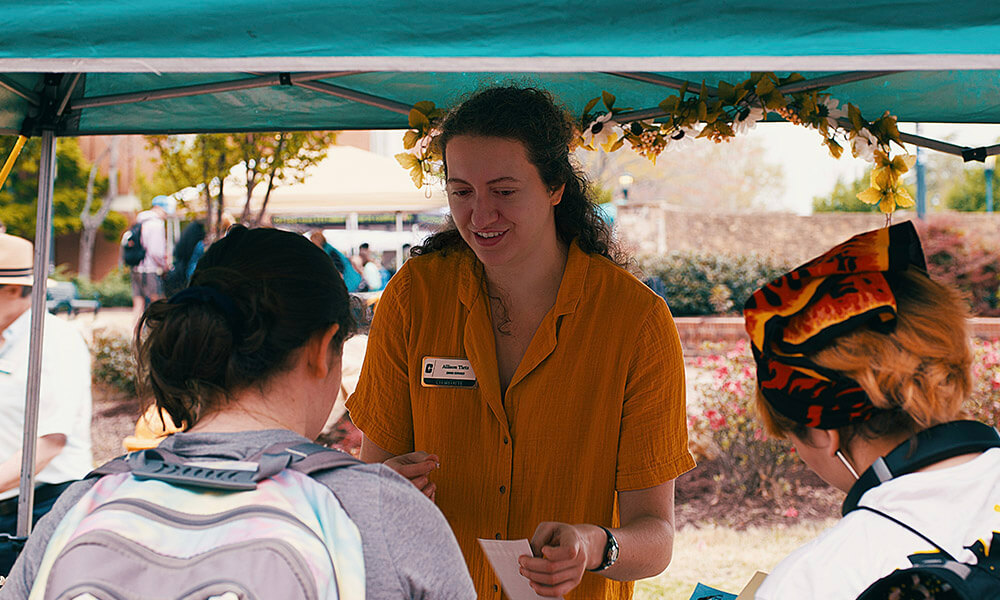 A staff member works at a tent during an event
