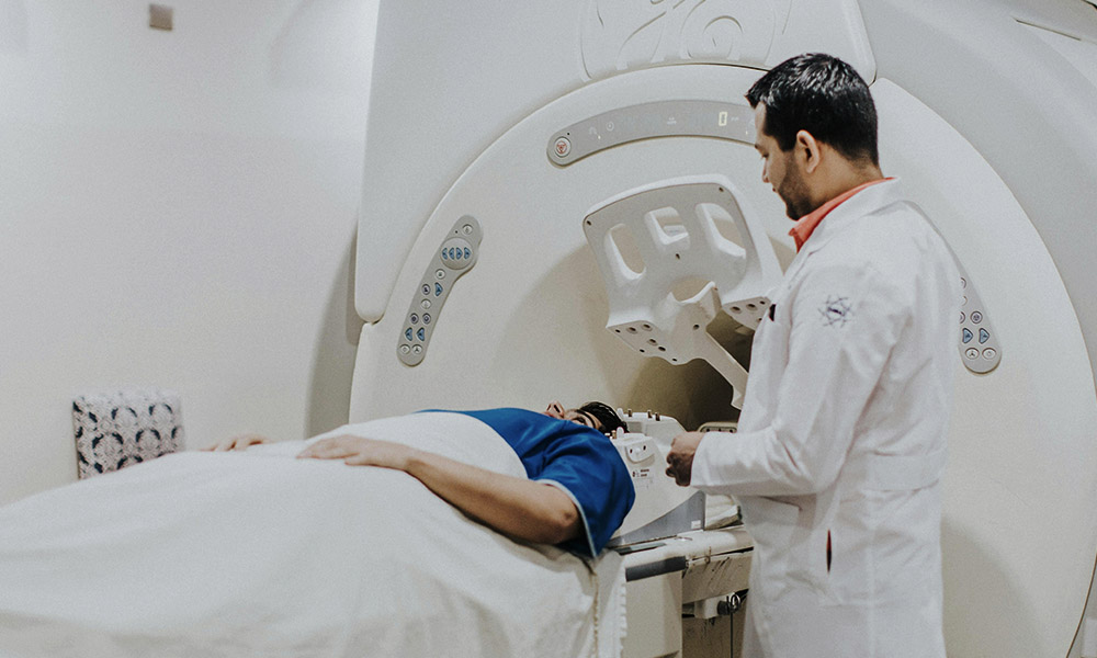 A patient lays down on a scanning bed
