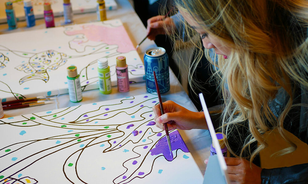 Patients work on paintings with vibrant colours