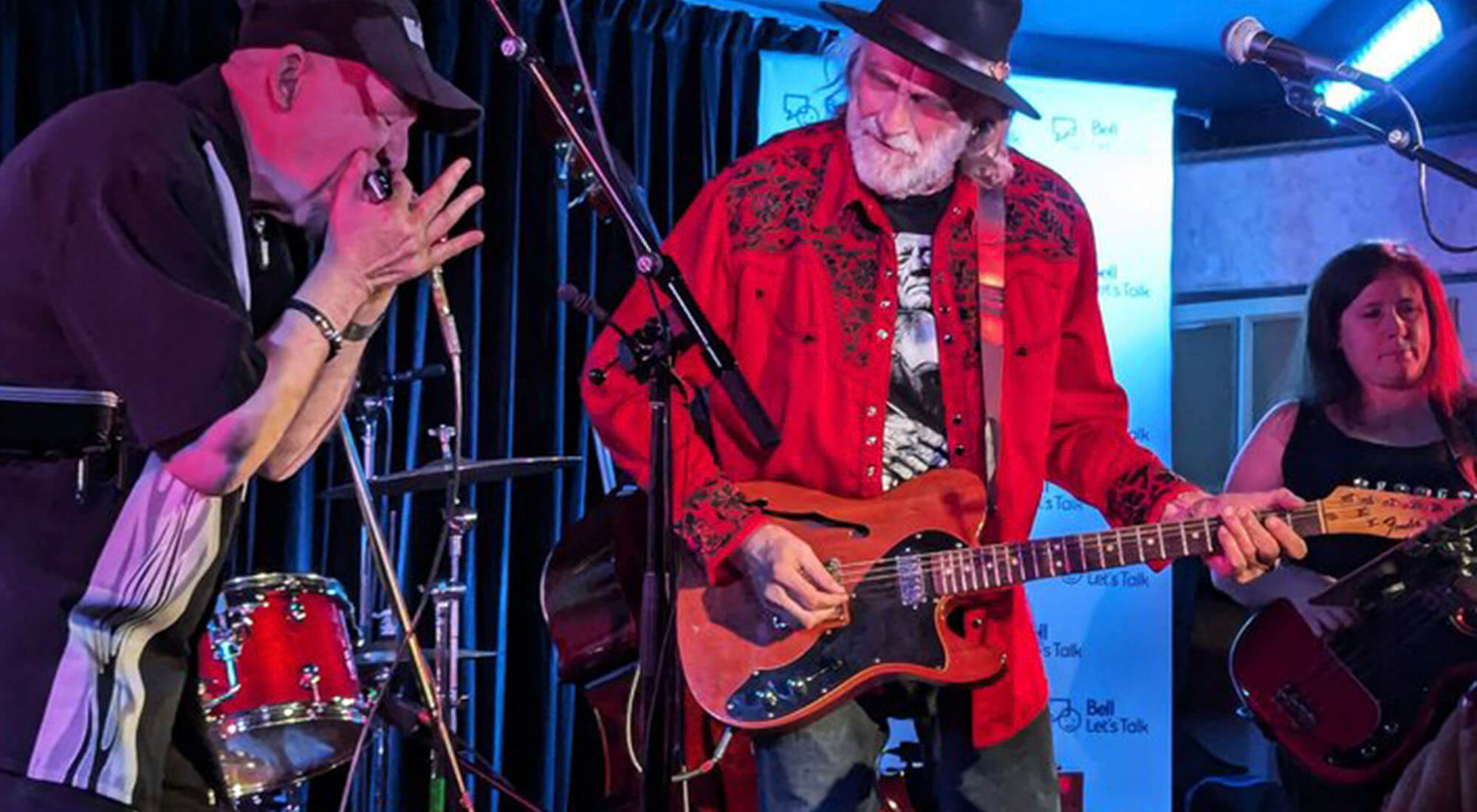 A group of musicians on stage perform for an event
