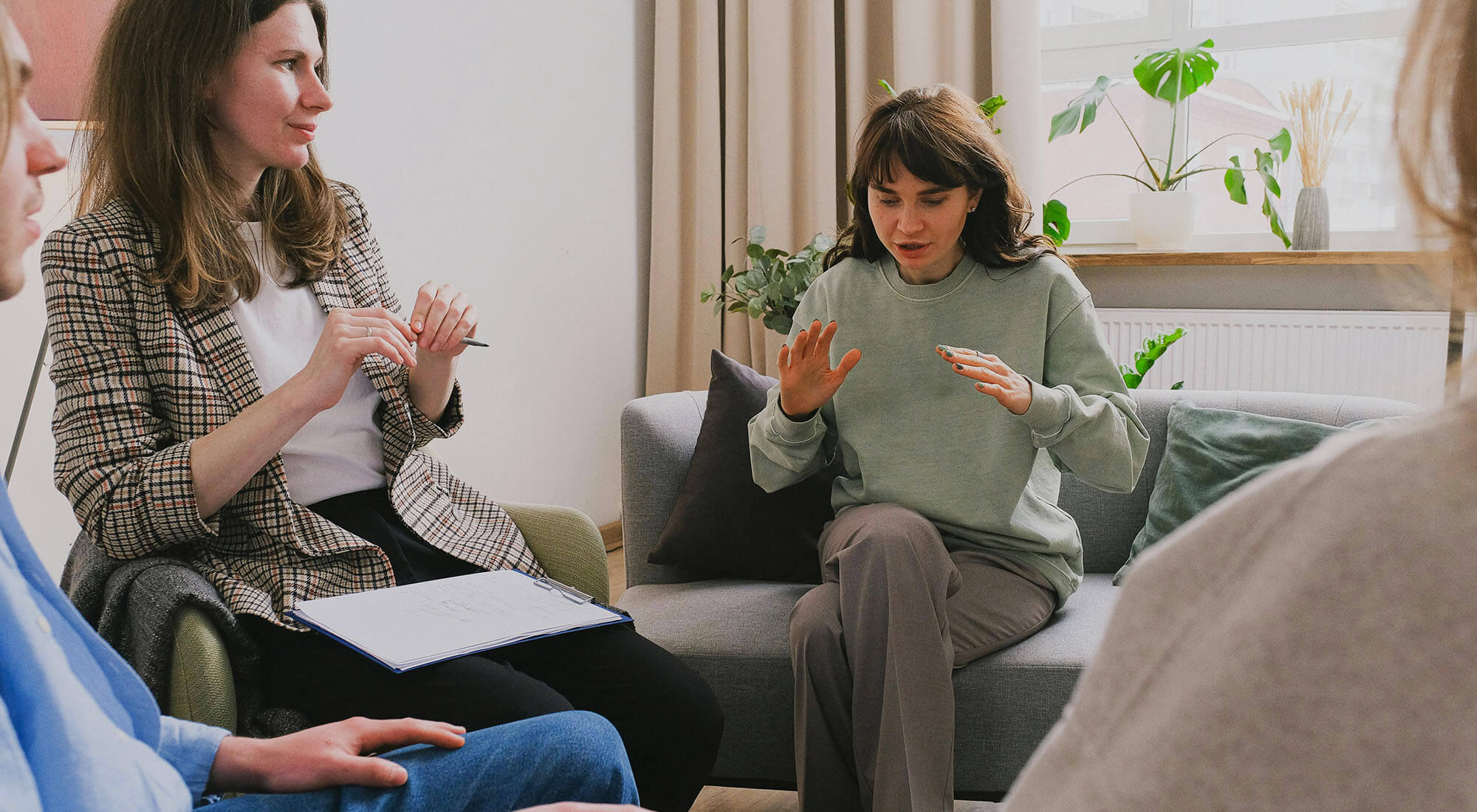 A group of people talk during a therapy session