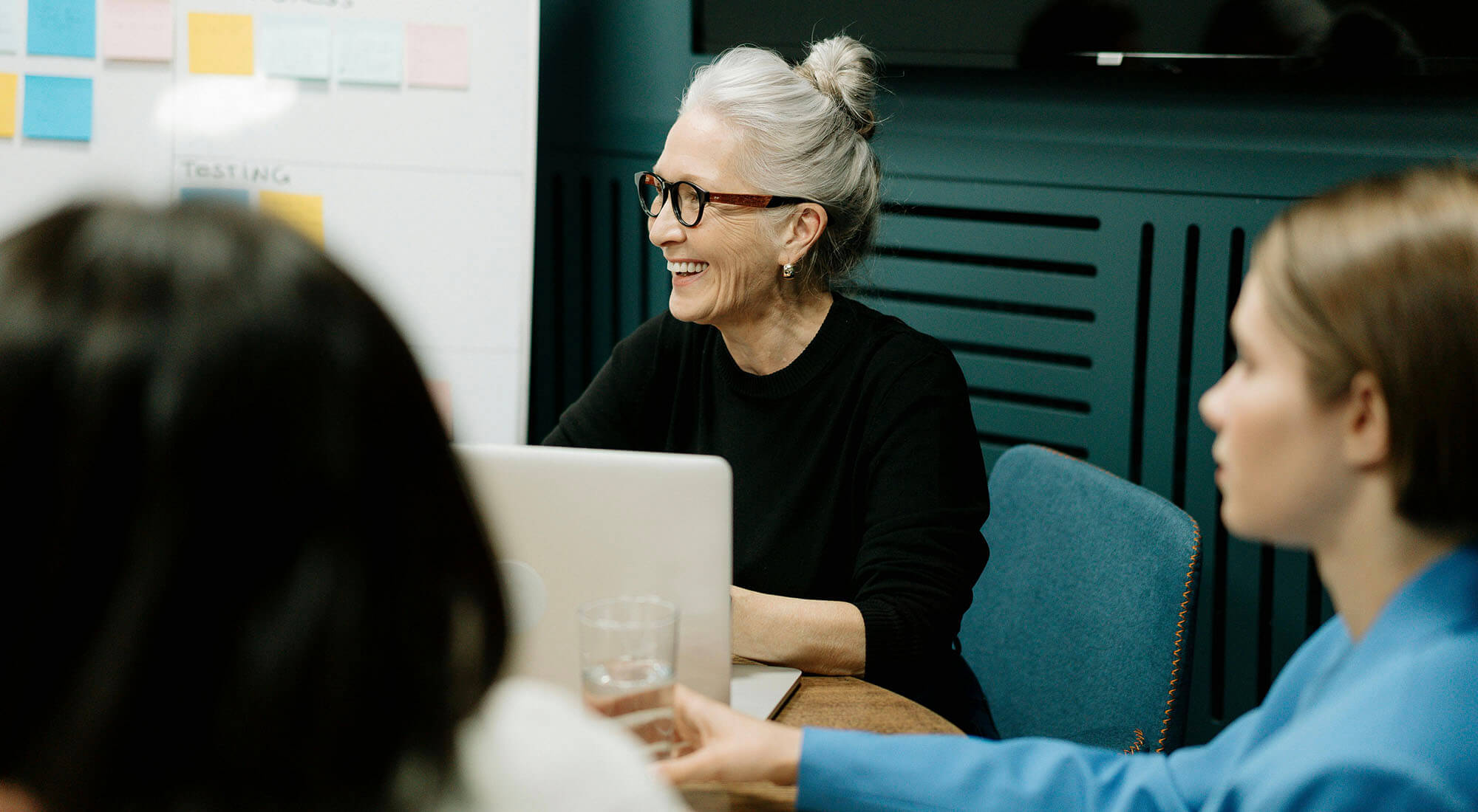 Volunteers talk at a table during a meeting