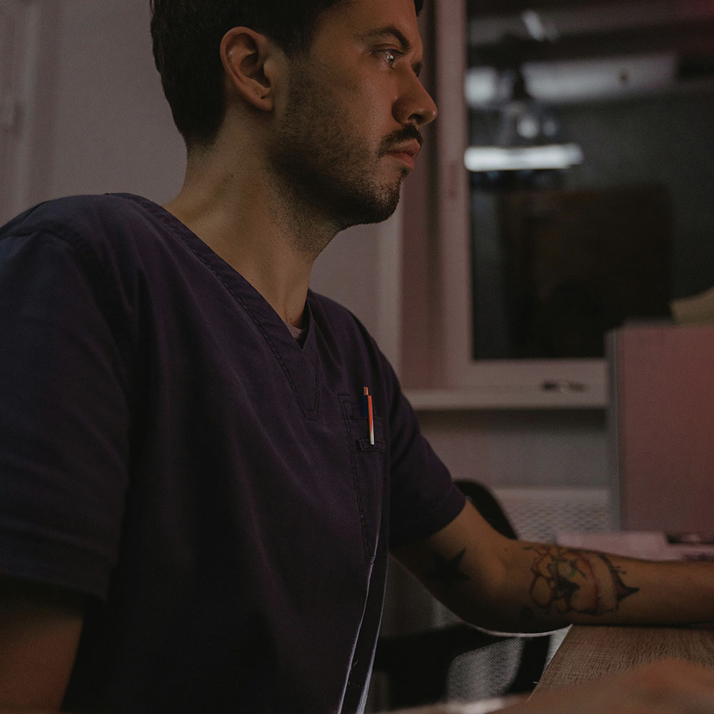 A man sits at a desk on his computer