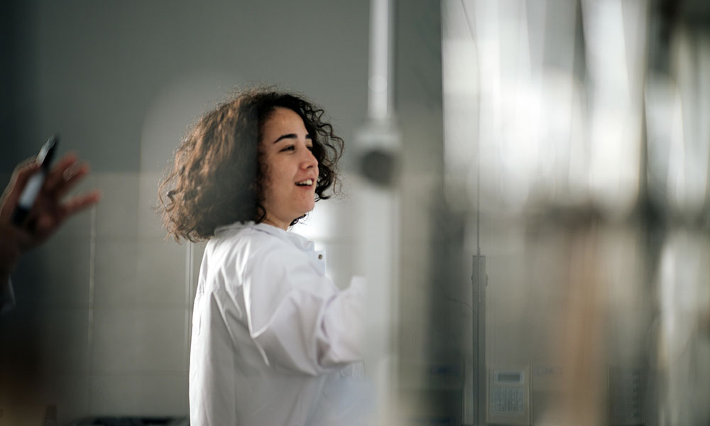 Someone pushes through a glass door