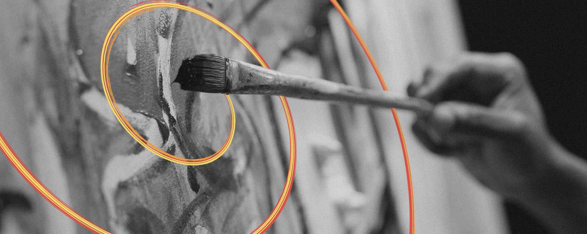 Black and white photo of painting, with colourful lines flowing from the brush.