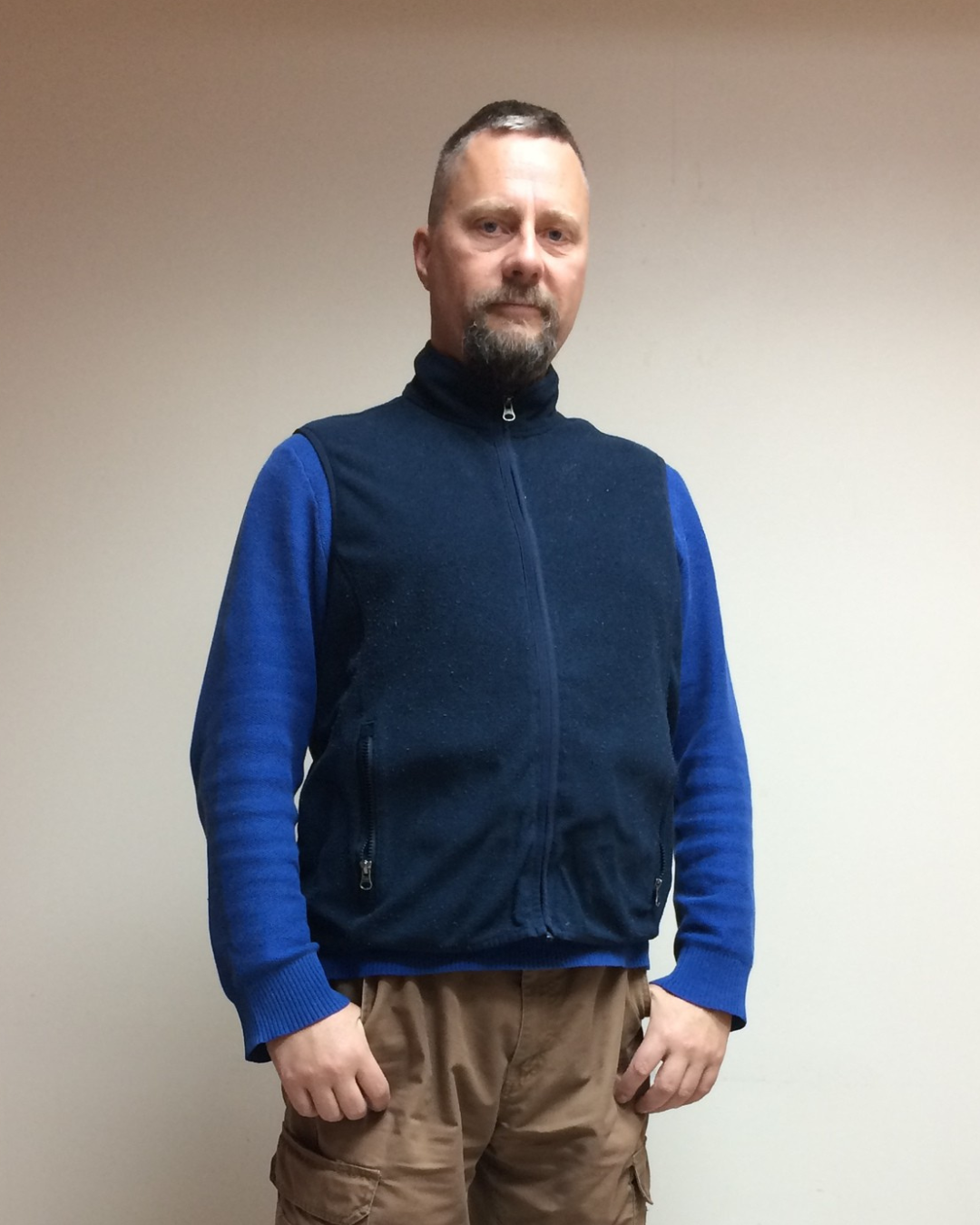 Michael, a past patient, standing in front of a neutral background.